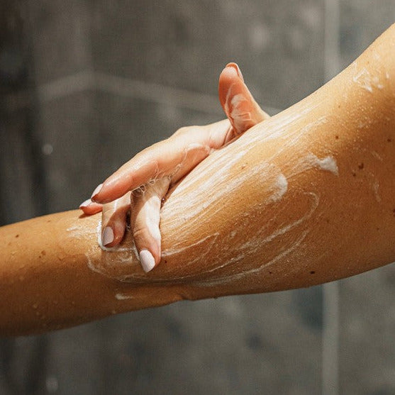 Close-up of the Myni Soft Skin Set powder-to-gel formula being gently scooped, showcasing its smooth, creamy texture and