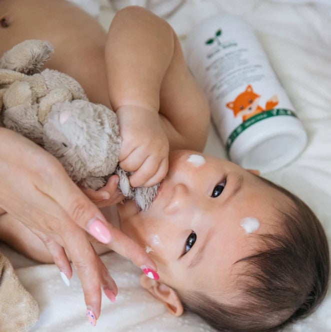 Close-up of Birch Baby Nourishing Lotion bottle cap and textured pump dispenser showing smooth, creamy formula inside