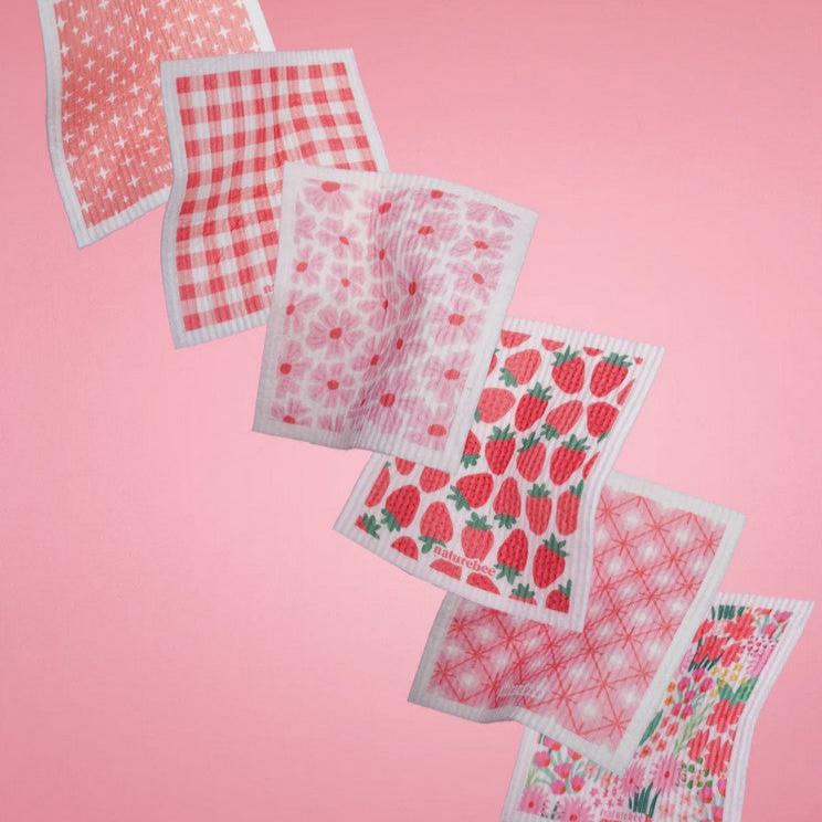 Close-up of pink bee design etched onto the textured surface of the Swedish cloth, highlighting detailed floral patterns and