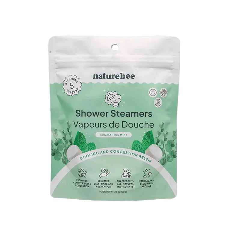 Close-up of Nature Bee Shower Steamers’ white background with visible mint and eucalyptus ingredients for a calming shower