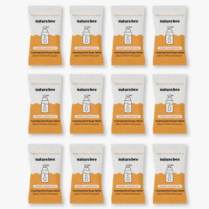 Close-up of the foaming hand soap tablets package showing citrus-themed label design and textured tablet surface.