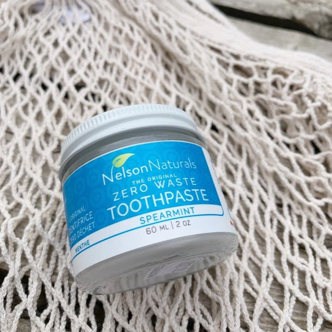 Close-up of the Nelson Naturals Spearmint Toothpaste jar displaying the textured, transparent glass surface and detailed