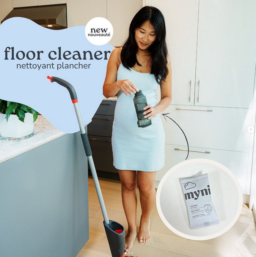 Myni Spray Mop Floor Cleaner Concentrate bottle in clear compostable packaging with blue cap, label displays brand and