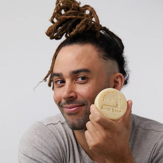 Close-up of the oatmeal-infused facial cleansing bar's textured surface showing natural exfoliants and creamy formula detail