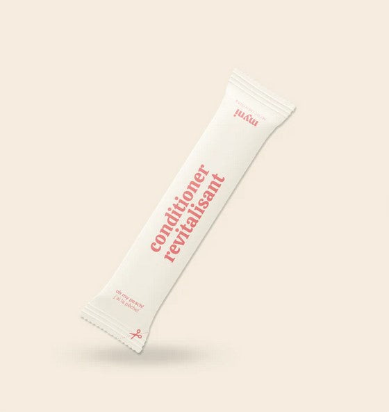 Close-up of Myni Conditioner’s handcrafted, eco-friendly packaging with detailed ingredient list and natural design accents