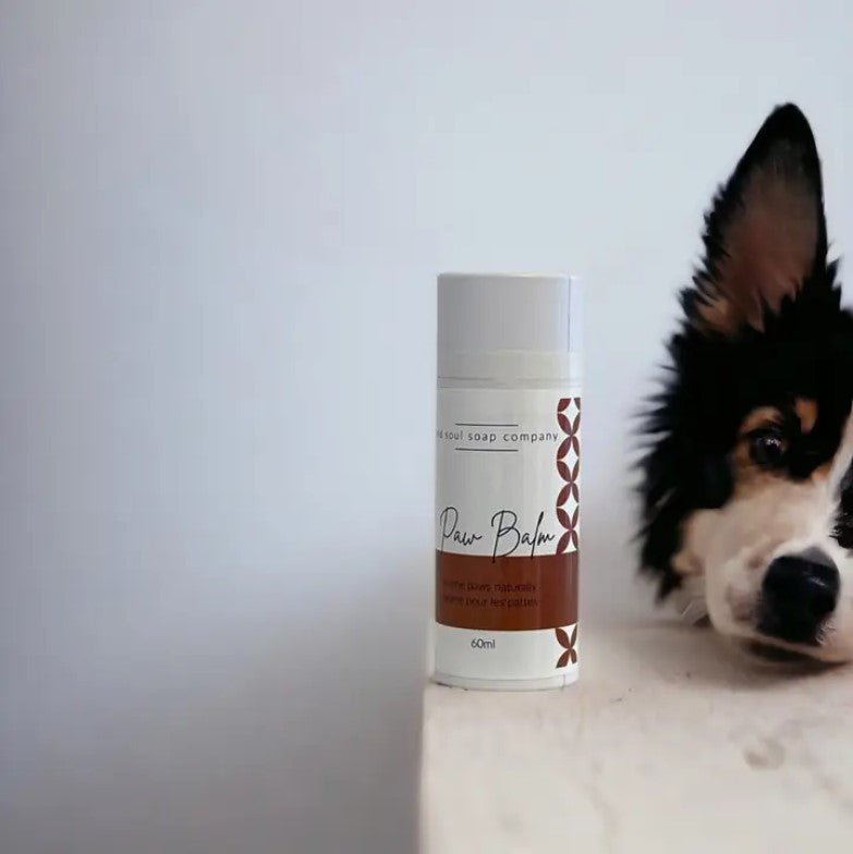 Close-up of Paw Balm tube's textured label detail highlighting eco-friendly branding and small size for easy application