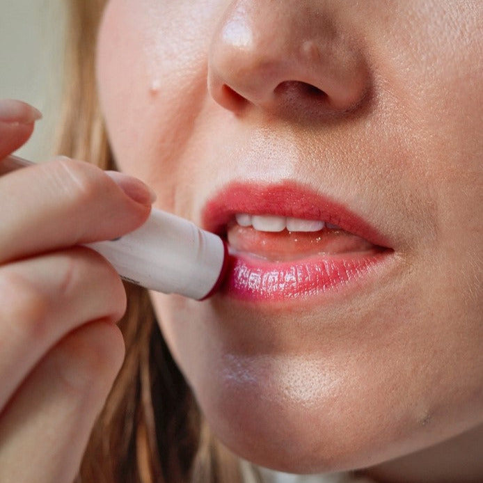 Applying peppermint tinted lip balm with natural sheen and subtle tint