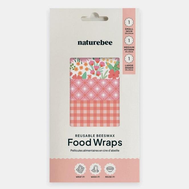 Close-up of the pink beeswax wrap's textured surface with visible organic cotton print and subtle honeybee illustration