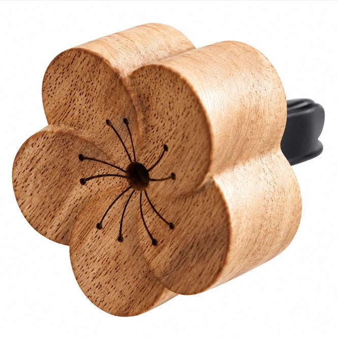 Plantish wooden flower essential oil car diffuser with vent clip on a white background.