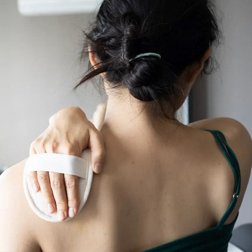 Close-up of textured exfoliating surface with white fibrous strands and bright yellow edge detail for gentle scrubbing