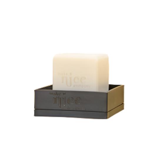 Close-up of the Make Nice Company soap dish tray's textured bamboo surface with drainage holes, showcasing its durable