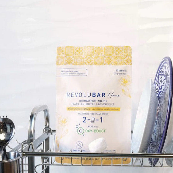 Revolubar dishwasher tablets stacked neatly, highlighting the compact rectangular packaging with clear branding and usage