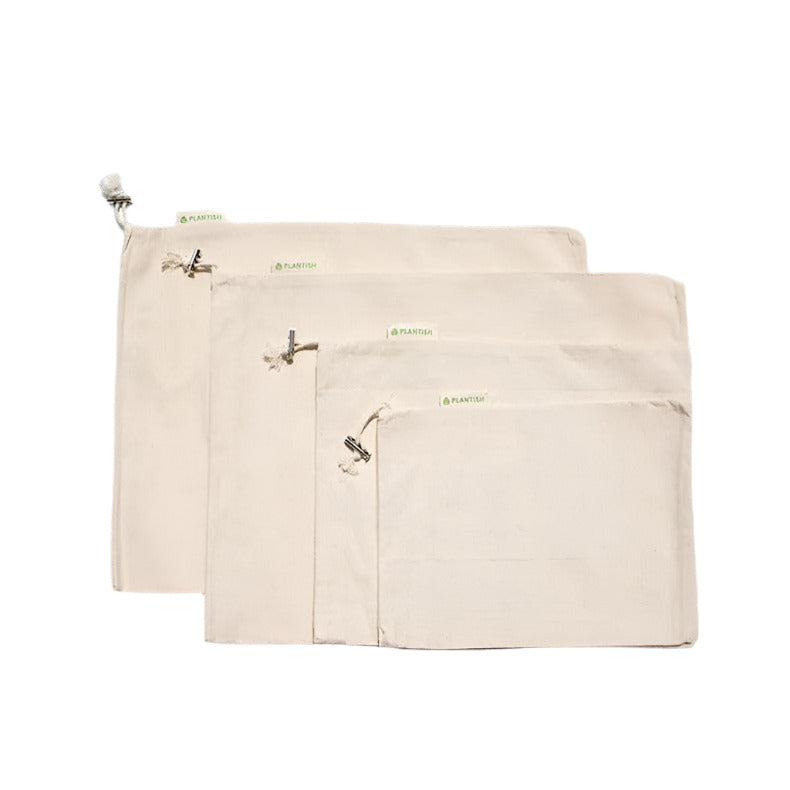 Close-up of textured organic cotton muslin bag fabric with subtle natural fibers and reinforced drawstring closure detail