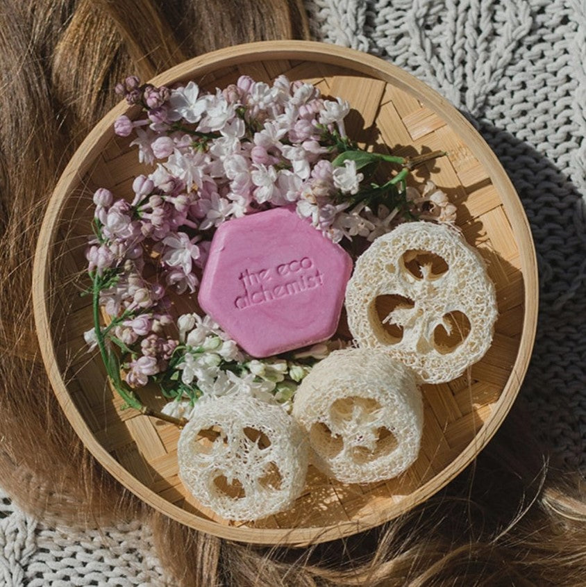Rad Hair Day Shampoo Bar nestled in flowers and natural loofah sponge, Canadian award-winning shampoo bar for dry damaged hair