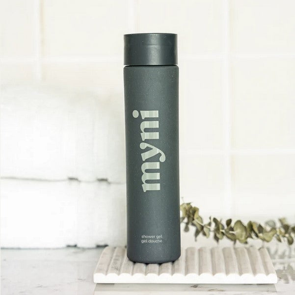 Close-up of Myni Shower Gel Starter Set label highlighting ingredients like aloe vera and chamomile, with textured gel