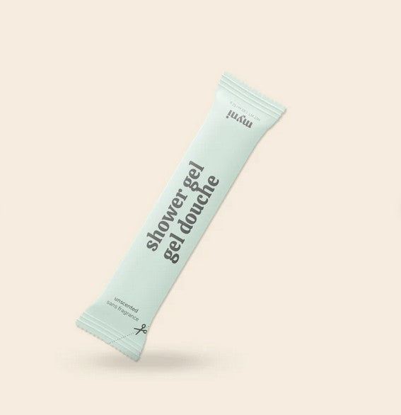 Close-up of Myni Shower Gel's textured, frothy surface highlighting its organic, hand-crafted ingredients in a clear