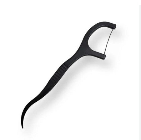 Close-up of the ClearXD reusable dental floss pick with textured eco-friendly bamboo handle and flexible floss segment