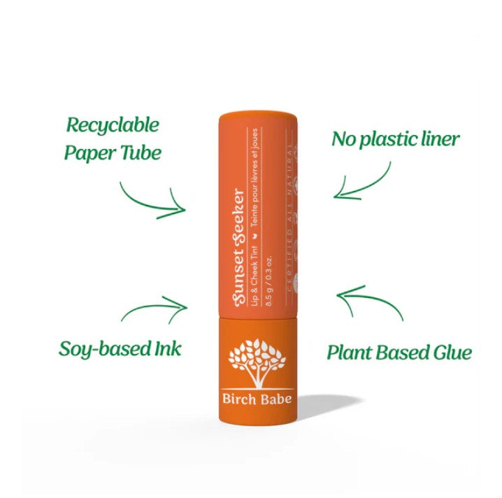 Close-up of Sunset Seeker Lip and Cheek Tint’s matte coral formula swatched on skin, showing smooth texture and vibrant