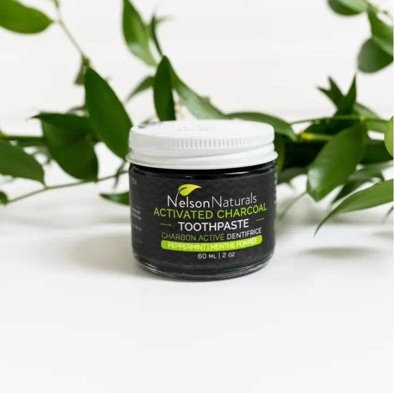 Close-up of the Nelson Naturals Activated Charcoal Toothpaste jar lid, showing textured surface and detailed branding