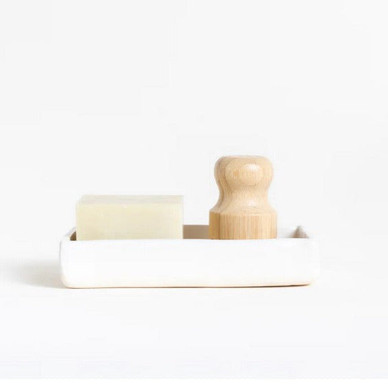 Close-up of the textured ceramic soap dish surface with drainage holes and sleek matte white finish, showcasing durability