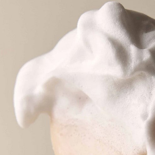 Close-up of a green Leaf Shave Soap Bar showcasing textured surface and embossed leaf logo detail