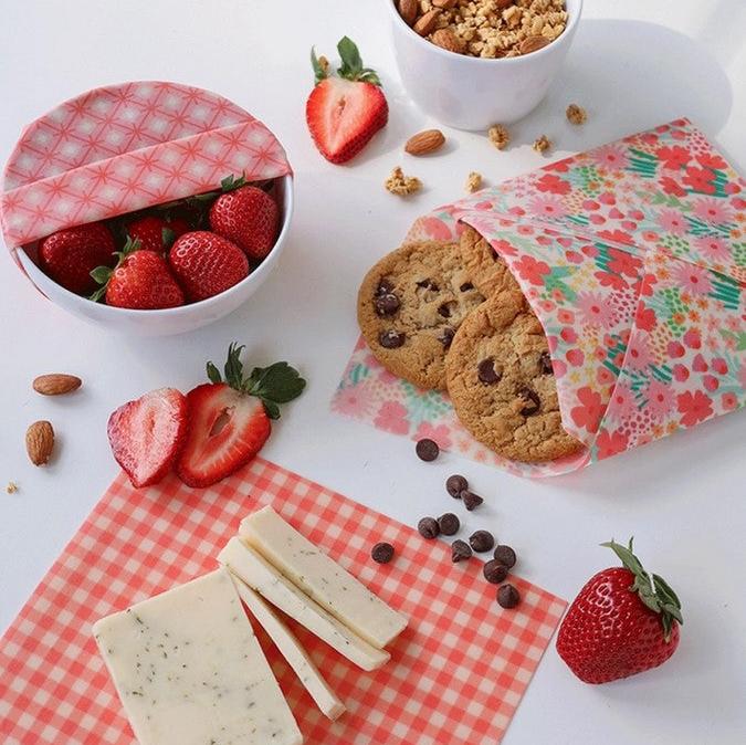 Close-up of colorful pink beeswax wrap edges showcasing hand-rolled seams and vibrant pattern details from above.