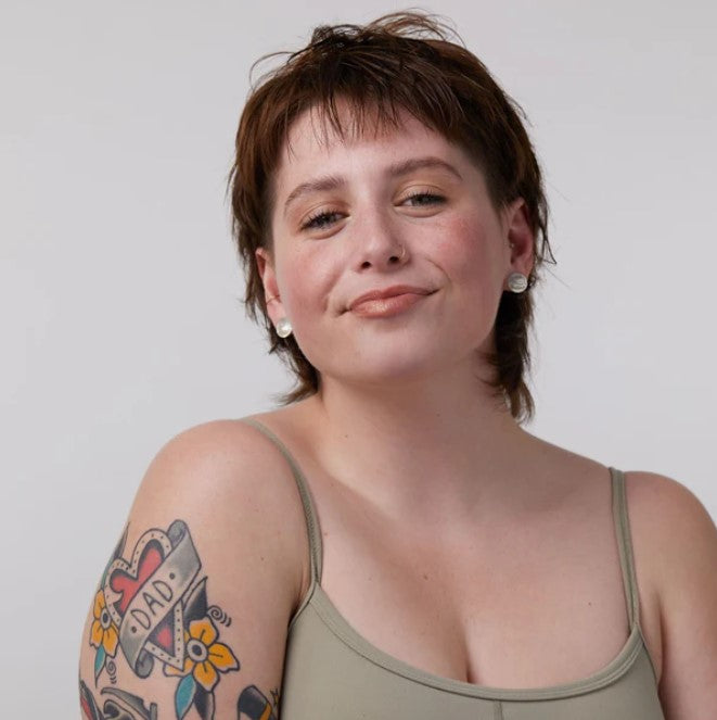 Close-up of the Dewy Bronze shimmer formula on skin, highlighting its smooth texture and lightweight, buildable application