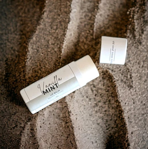 Close-up of the Vanilla Mint Lip Balm tube cap displaying textured ridges and clear branding lettering