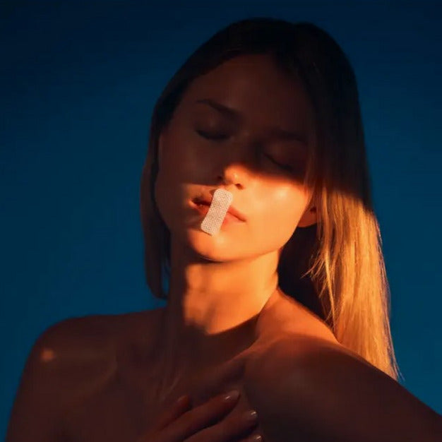 Close-up of the mini mouth tape strips showing transparent, flexible material with textured adhesive surface for comfortable