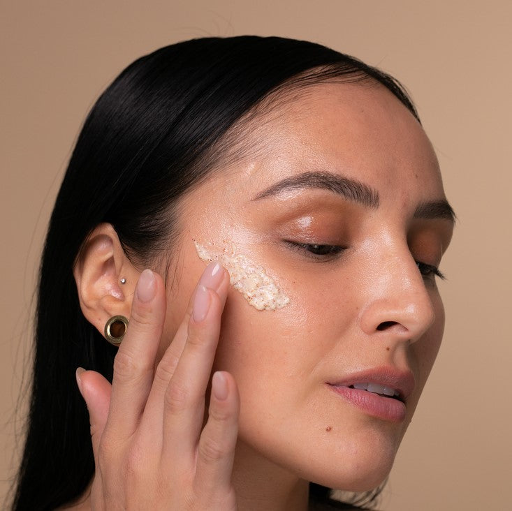 Close-up of Gentle Face Scrub’s creamy textured formula with visible exfoliating beads and soft floral scent indicators on