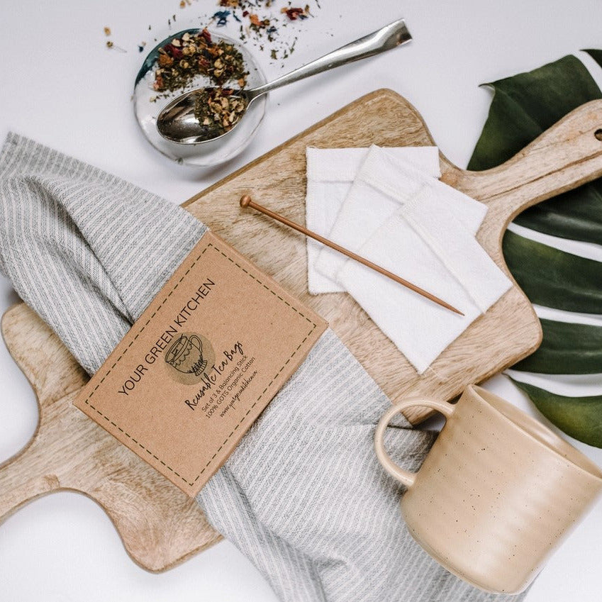 Close-up of individual reusable tea bags displaying eco-friendly organic cotton material and clear label tags for easy