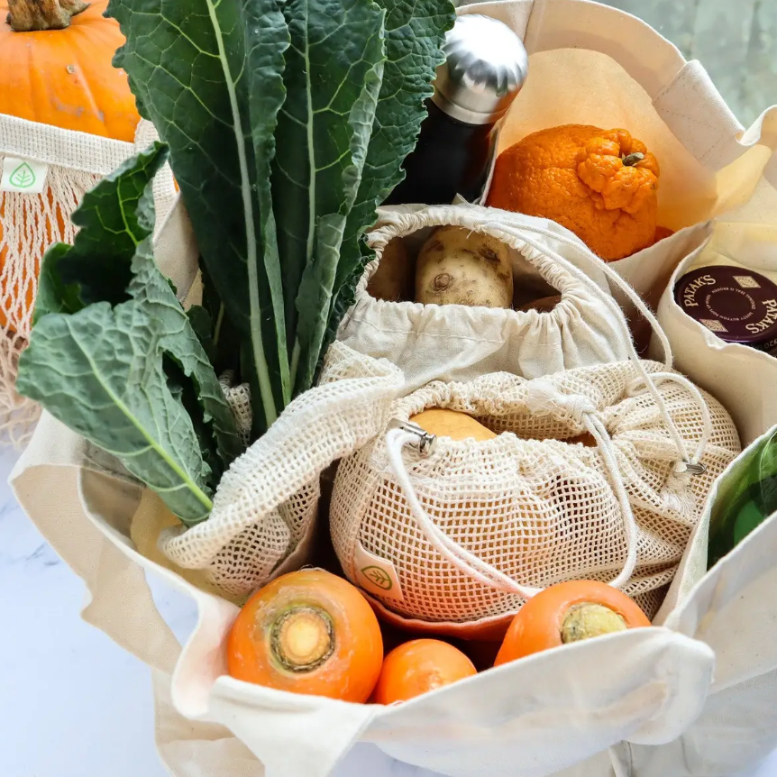 Close-up of the multi-pocket tote's reinforced leather strap attachment and textured canvas surface for durability