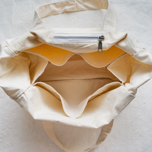 Plantish multi-pocket tote bag with navy blue canvas exterior, reinforced handles, and multiple compartments for shopping