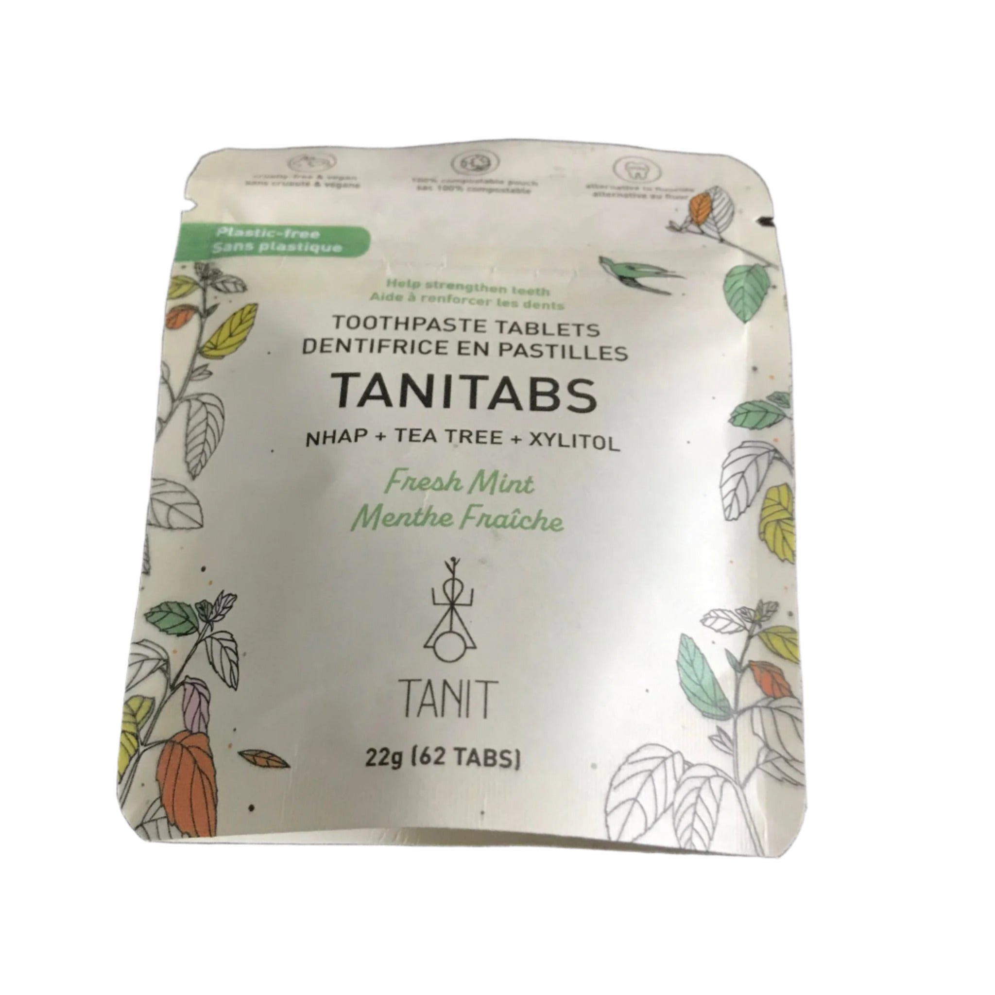 Close-up of TANITABS Fresh Mint toothpaste tablets inside clear plastic container, highlighting individual mint-colored