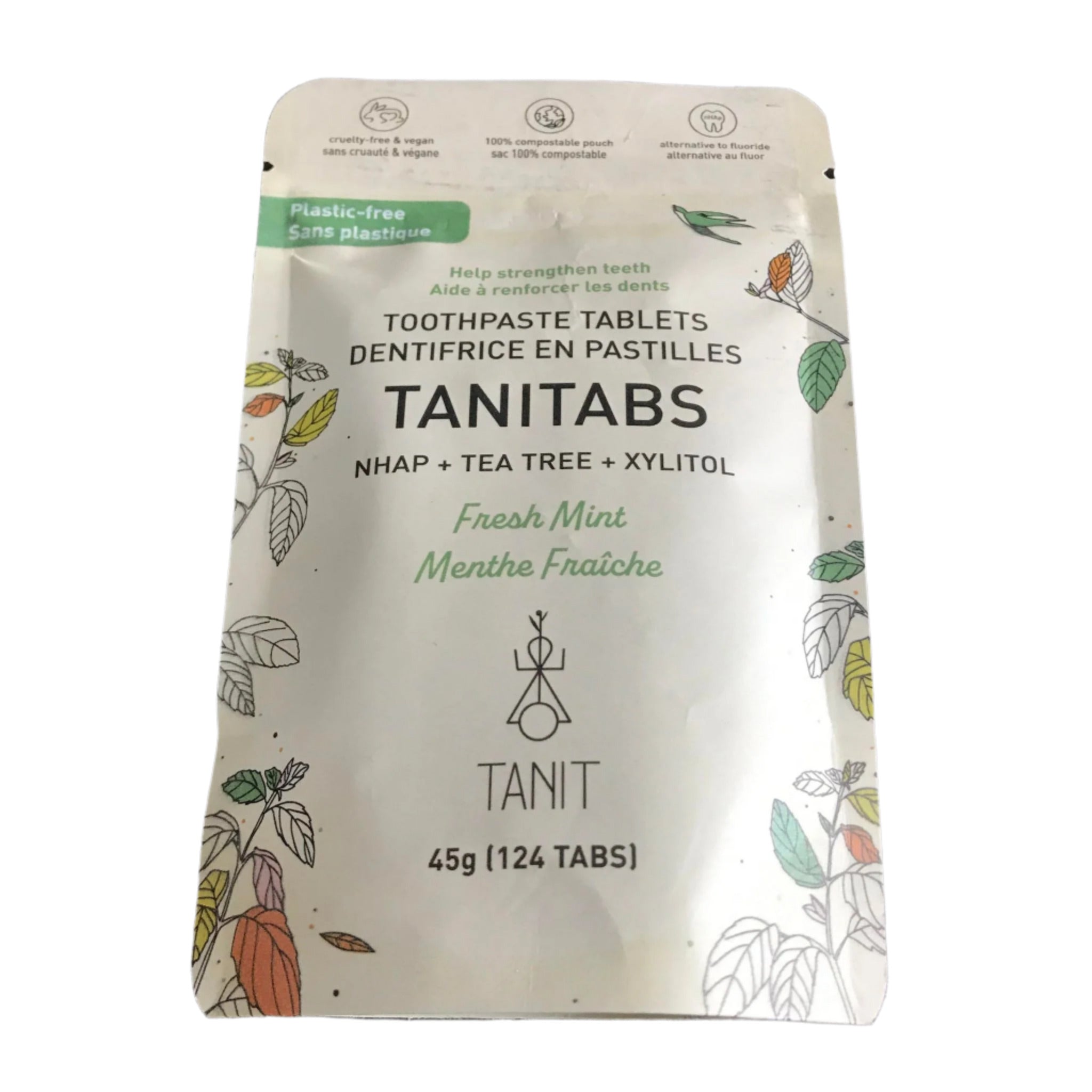 Close-up of TANITABS Fresh Mint Toothpaste Tablets showing textured surface and vibrant mint color in clear container lid