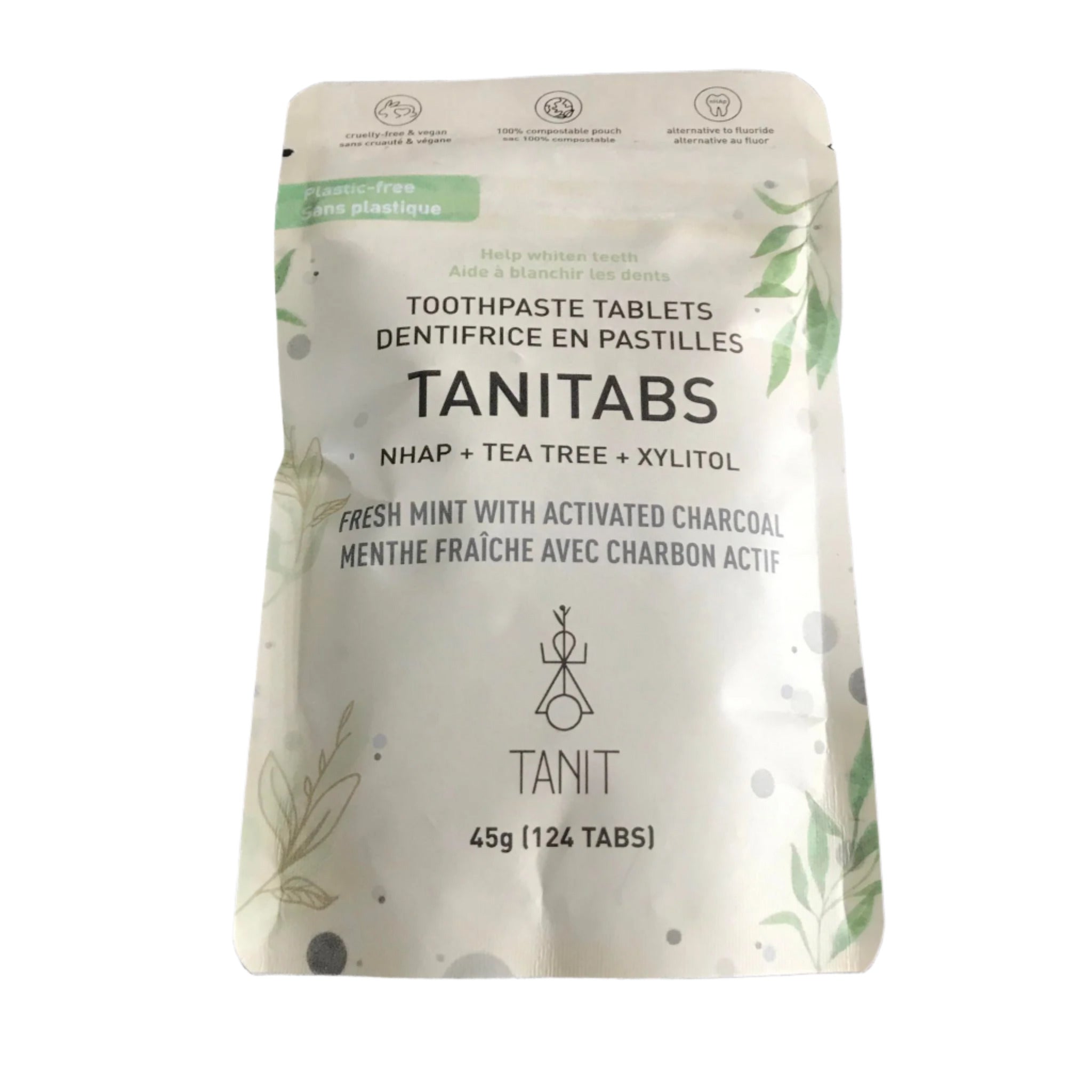 Close-up of TANITABS Activated Charcoal Mint Toothpaste Tablets in clear glass jar showing textured tablets and bright mint