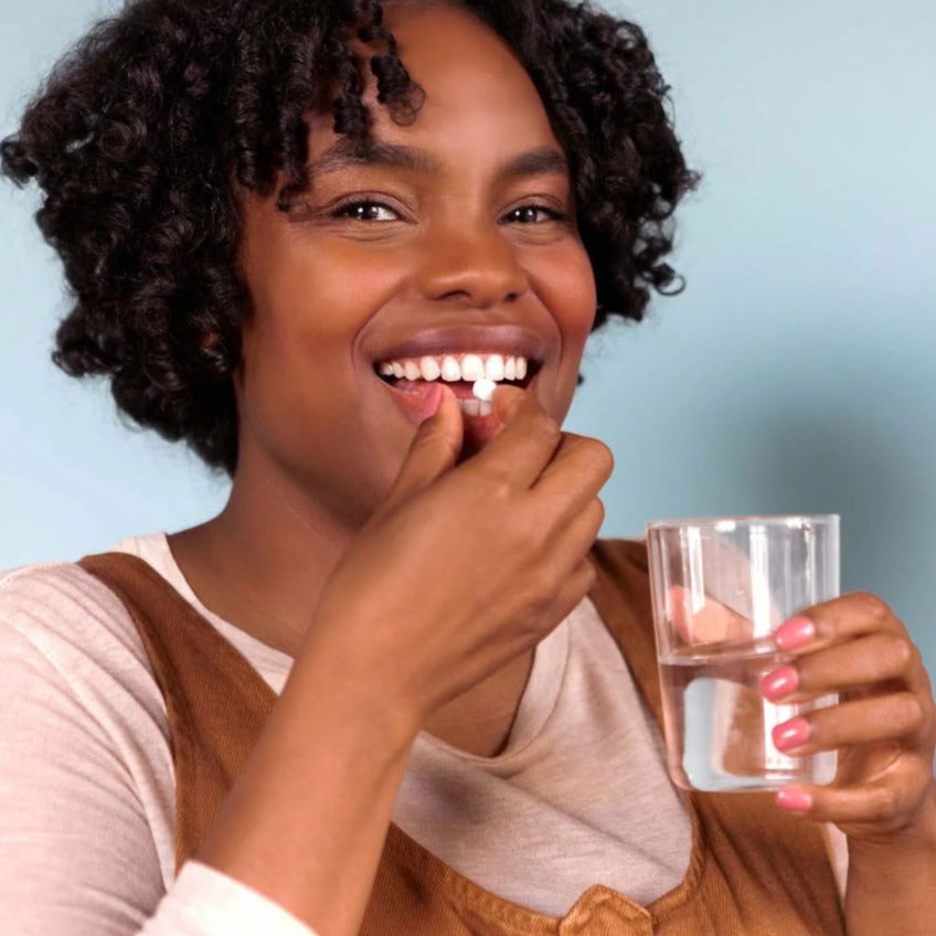 Close-up of TANIT Mouthwash Tablets container showing textured tablet surface and clear dosage instructions on label