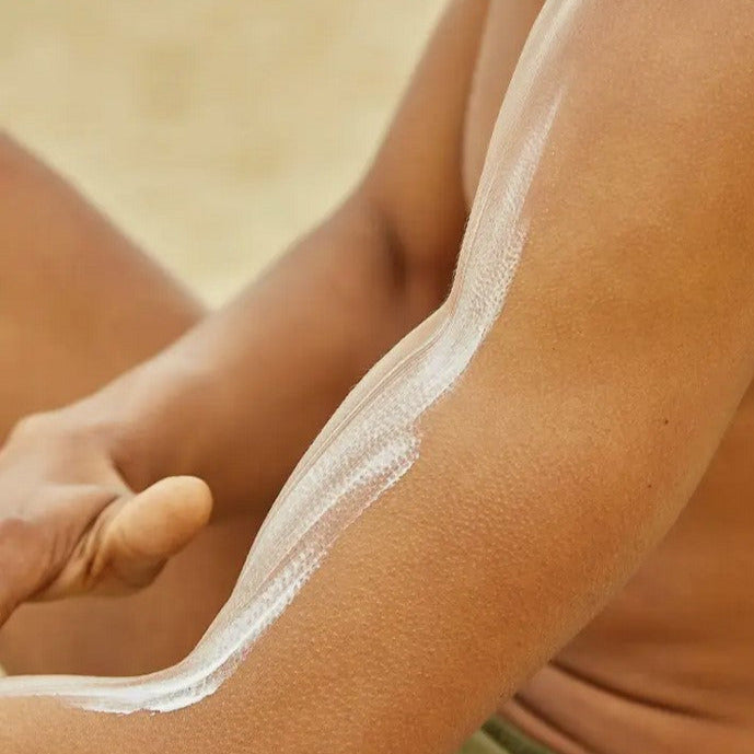 Close-up of Tanit Botanics Mineral Sunscreen tube showing textured formula and eco-friendly packaging with subtle scent hints