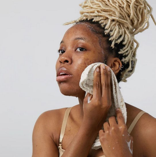 Close-up of the charcoal-infused cleansing bar’s textured surface with visible specks and a subtle scent hint on the