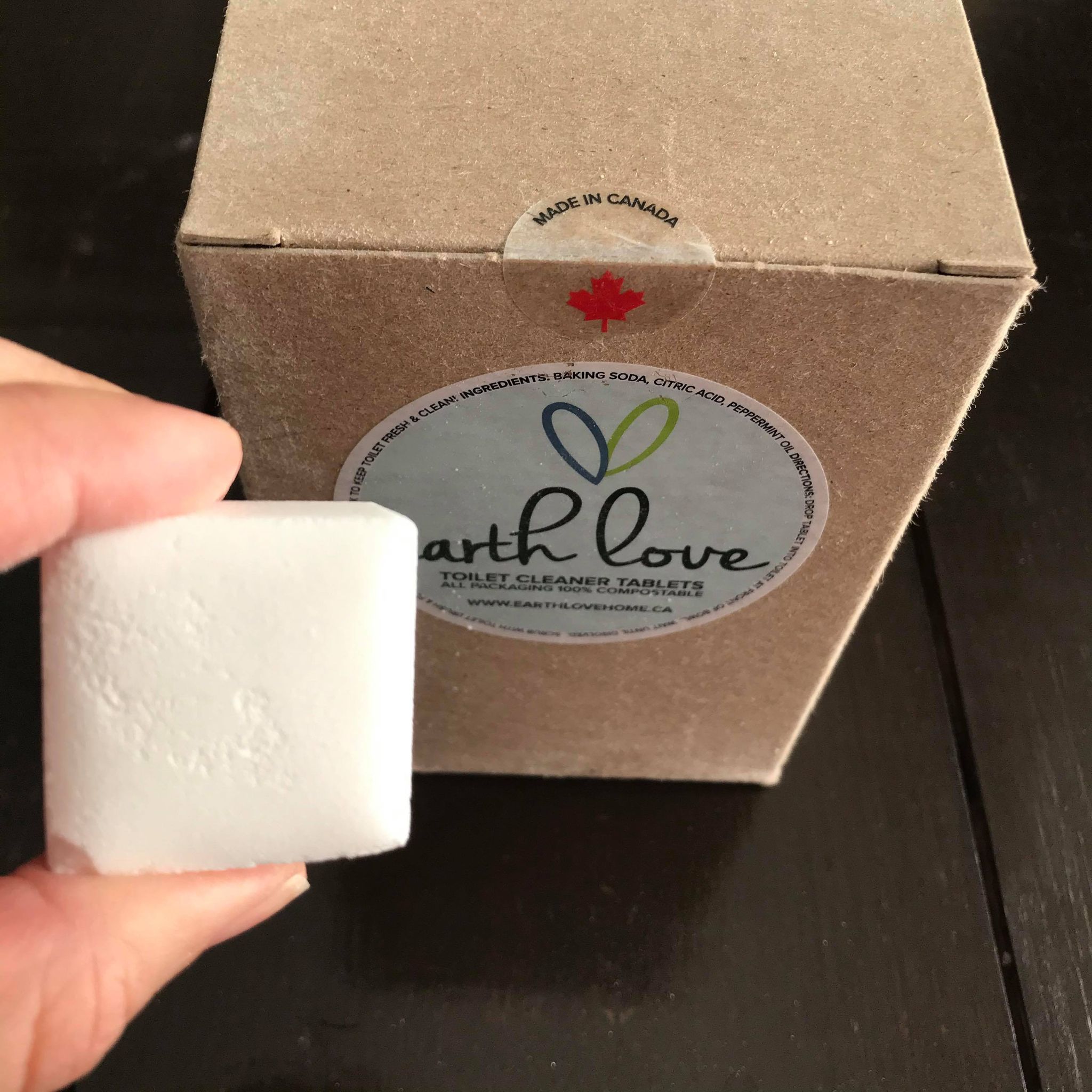 Close-up of Earth Love Toilet Cleaner Tablets packaging highlighting eco-friendly label and compact cube shape.