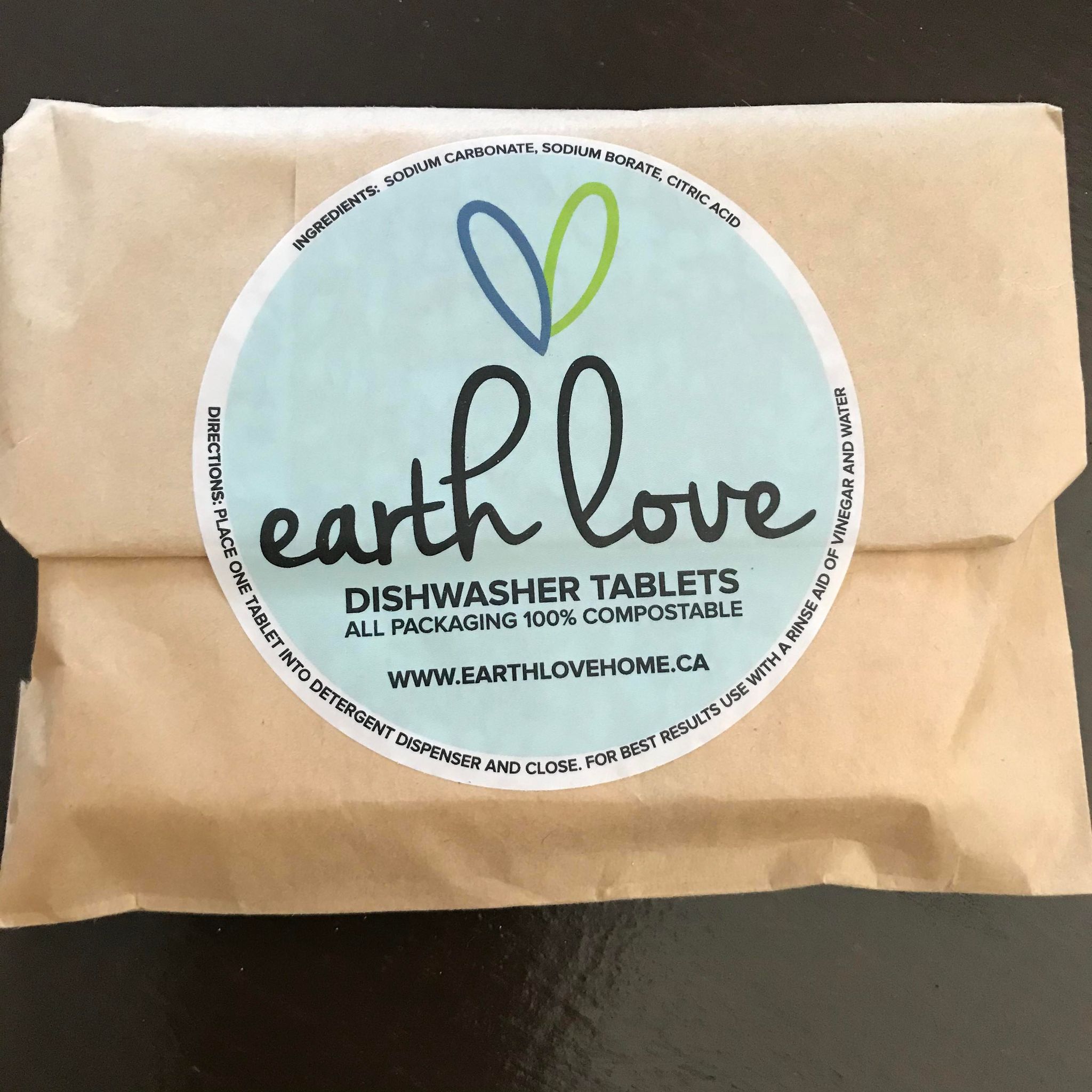 Close-up of Earth Love Dishwasher Tablets packaging highlighting eco-friendly label and textured material surface