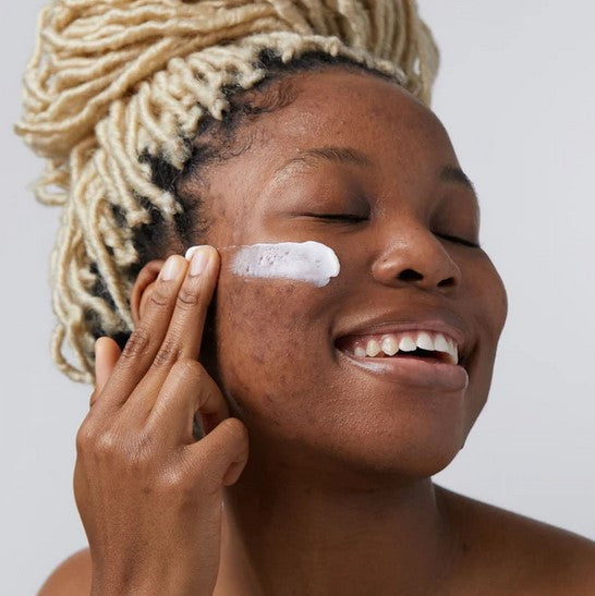 Close-up of Birch Babe Hydrating Face Cream jar showing textured surface and soft scent notes on label text