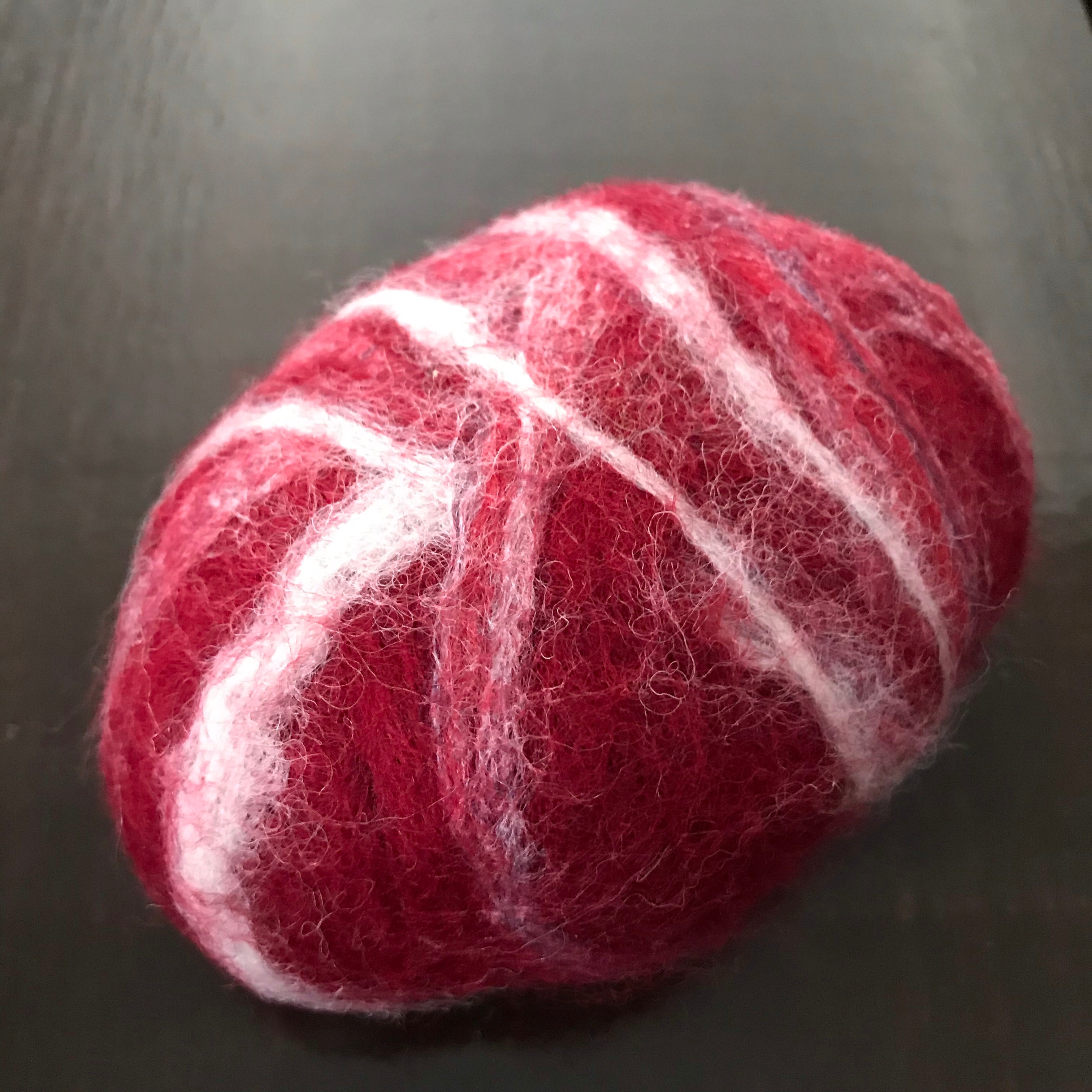 Close-up of the felted apple cinnamon soap's textured surface revealing detailed fibrous layers and subtle cinnamon specks.