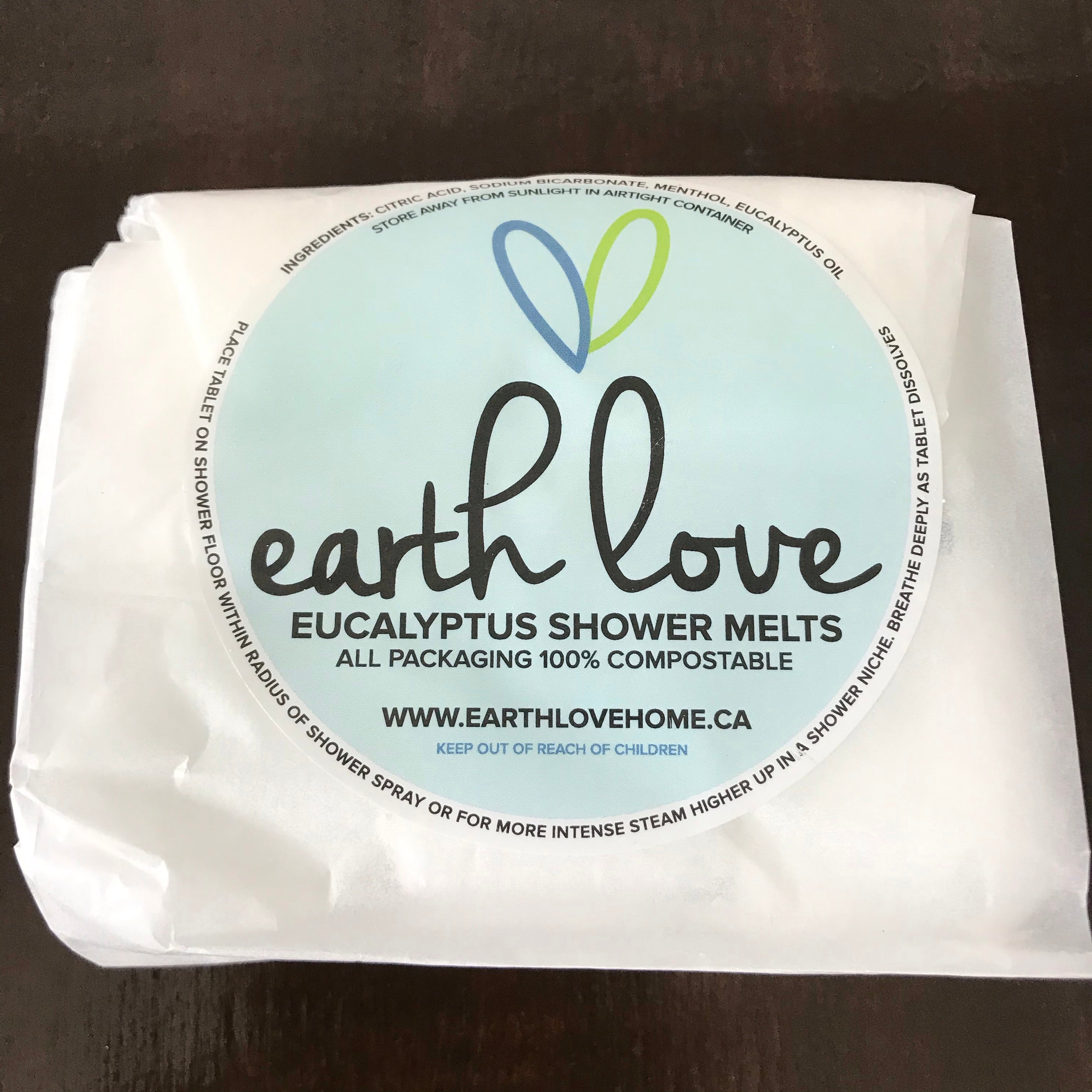 Close-up of Earth Love Eucalyptus Shower Melts with textured surface and natural specks, showcasing handmade, organic
