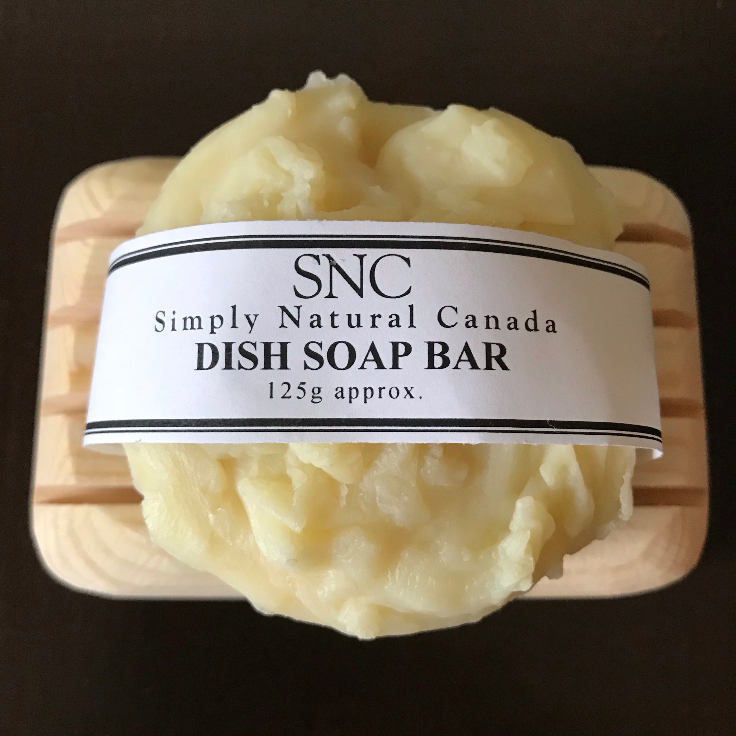 Close-up of the textured natural soap bar surface with visible embedded plant fibers and a slightly rough finish