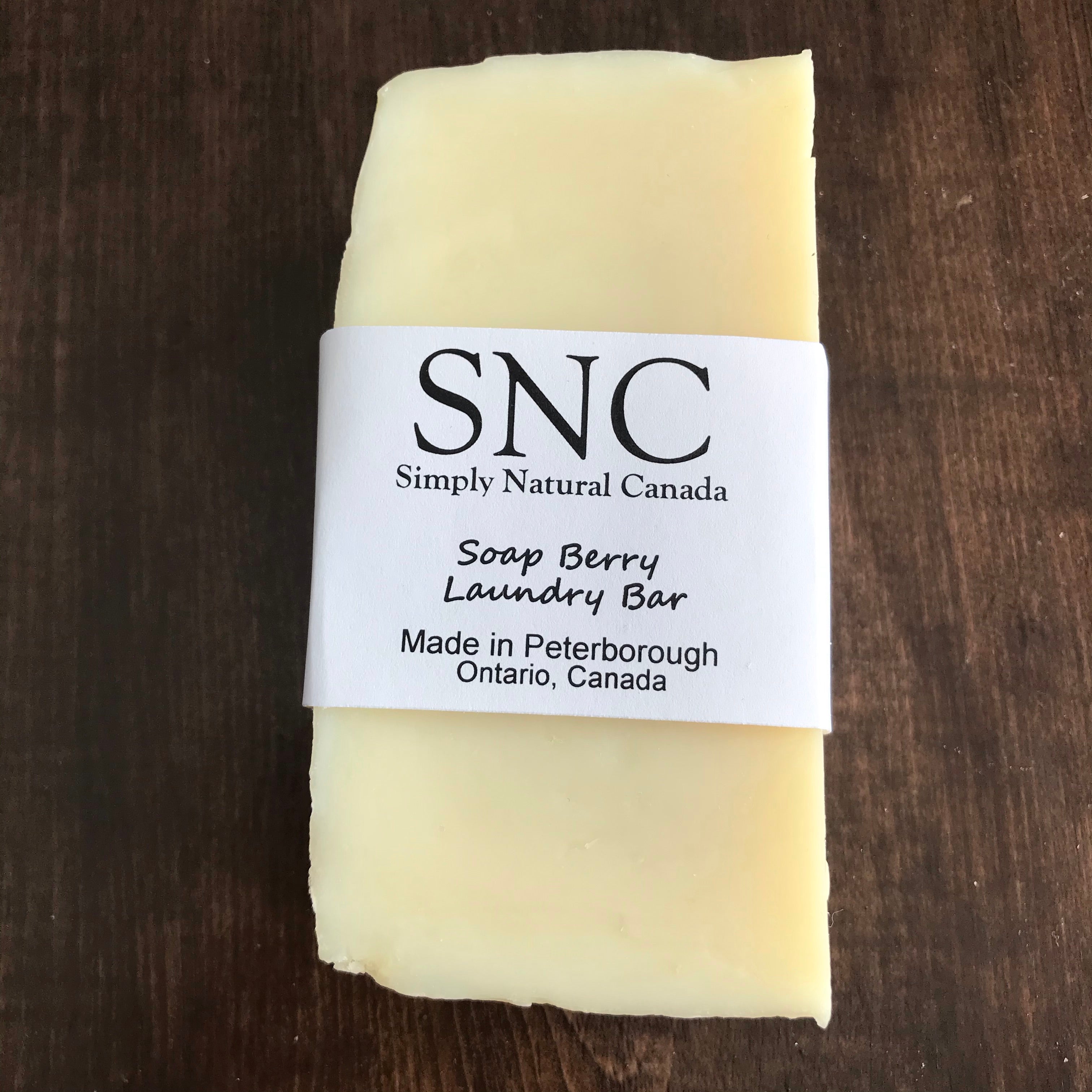 Close-up of the Soap Berry Laundry Bar's textured, unscented surface with visible natural fibers and rustic brown color