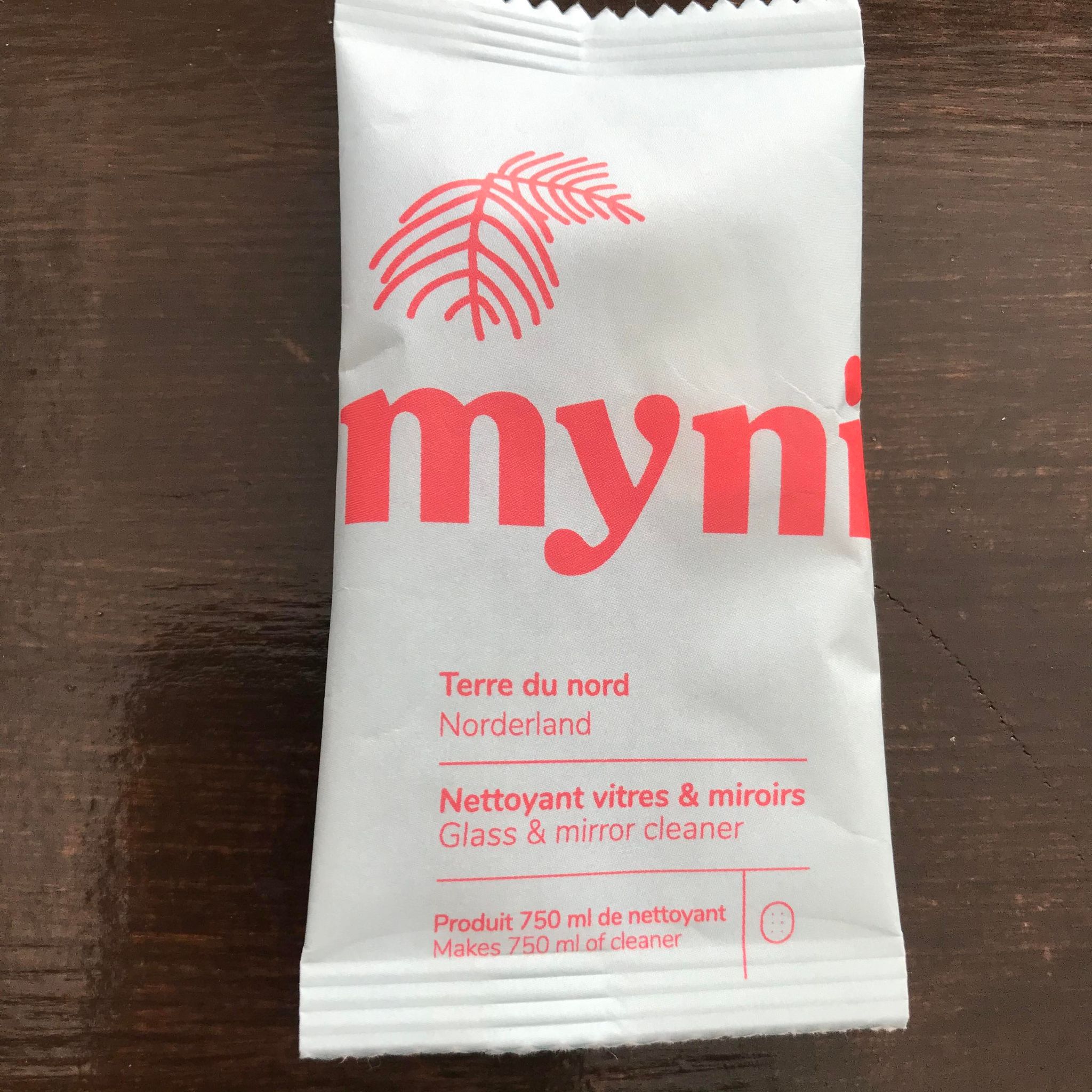 Close-up of Myni cleaning tablets packaging showcasing the textured label and compact size on a white background.