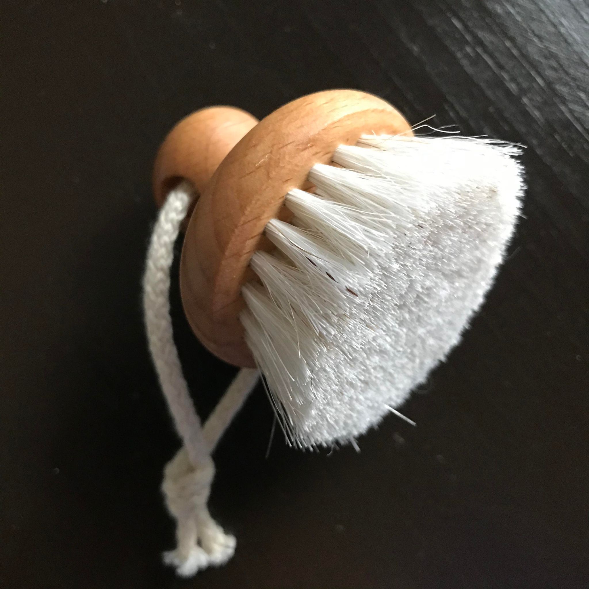 Close-up of the face brush's soft, textured sponge showing fine pores designed for gentle exfoliation and smooth application.