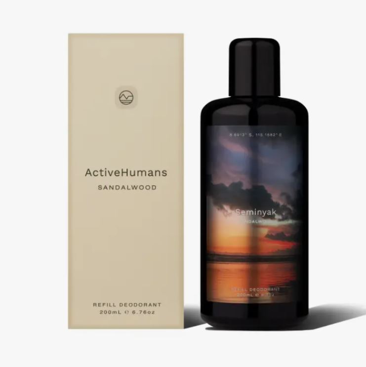 Close-up of the spray nozzle with clear steam mist release and textured natural wood-colored plastic container.