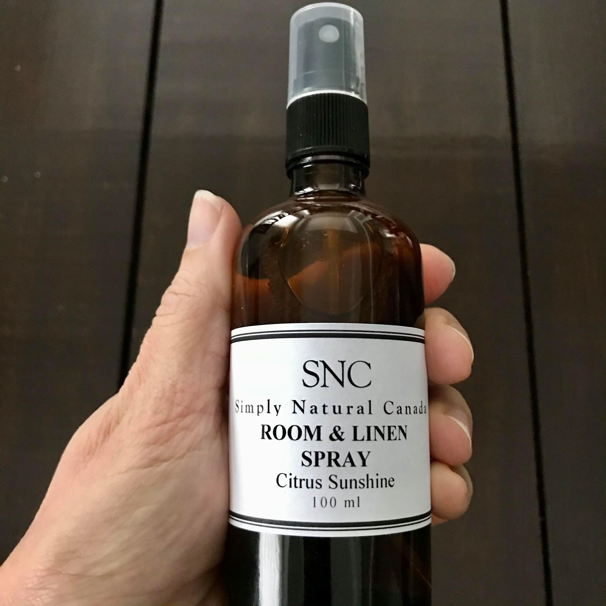 Close-up of the lavender-scented spray bottle’s textured glass surface and delicate frosted label detail